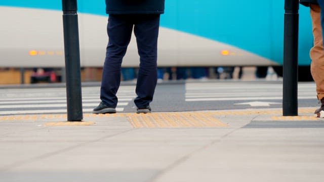 People waiting for crosswalk signal