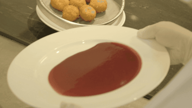 Bowl in which chef spreads red sauce