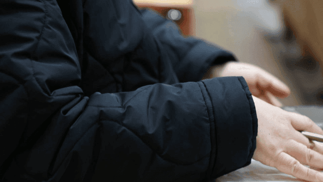 Person taking notes in a lecture hall