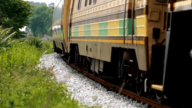 Country train running through blue landscape