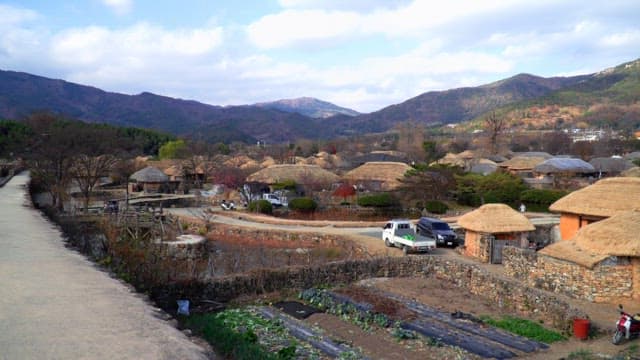 Rural village with thatched-roof houses in the mountains