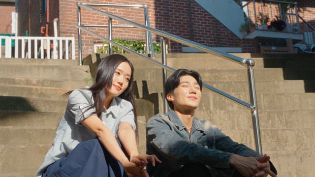 Couple sitting on outdoor steps in sunlight