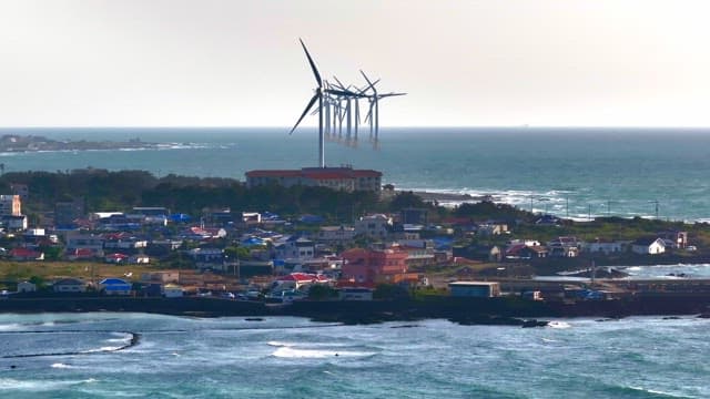 Coastal town with wind turbines by the sea