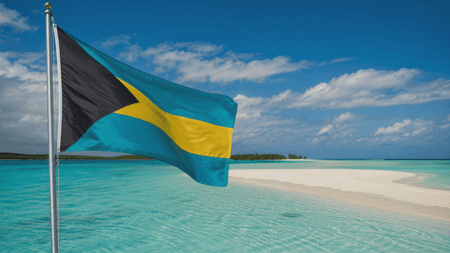 Bahamian flag fluttering on tropical beach
