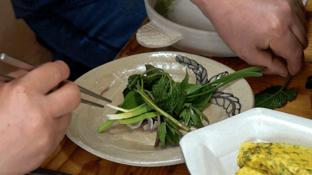 Chopsticks for picking up fresh vegetables and meat on plate