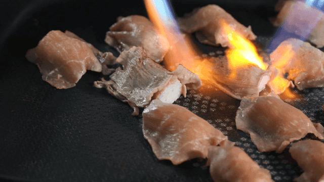 Torching raw meat on a grill