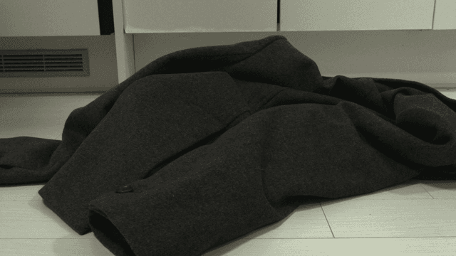 Person who takes off his coat and leaves it on floor