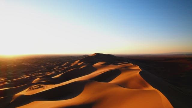 Golden Sunrise Over Serene Desert Dunes