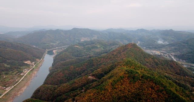 Serene River Winding Through Autumn Mountains