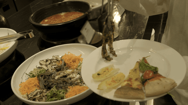 Person who arranges various dishes on plates at buffet