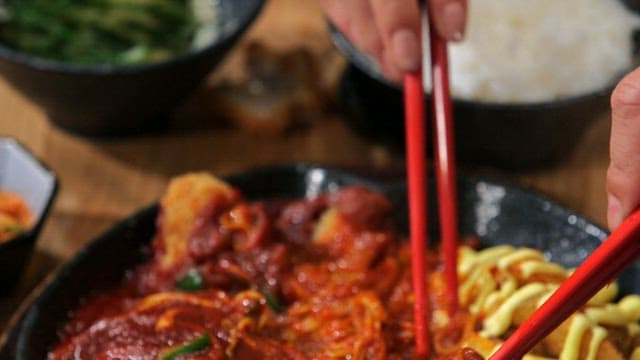 Spicy pork cutlet with spicy sauce with chopsticks