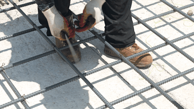 Worker tying rebar on a construction site