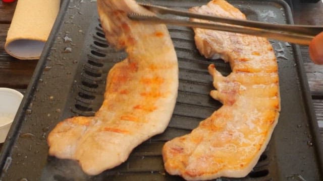 Pork belly grilled on a hot grill