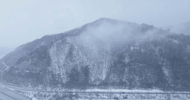 Snow-covered mountains with mist