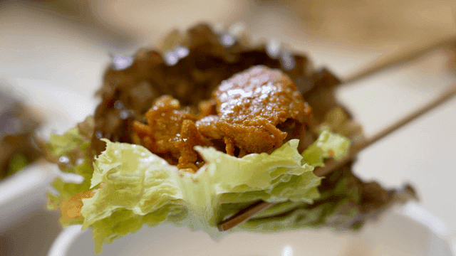 Stir-fried spicy pork wrapped in lettuce