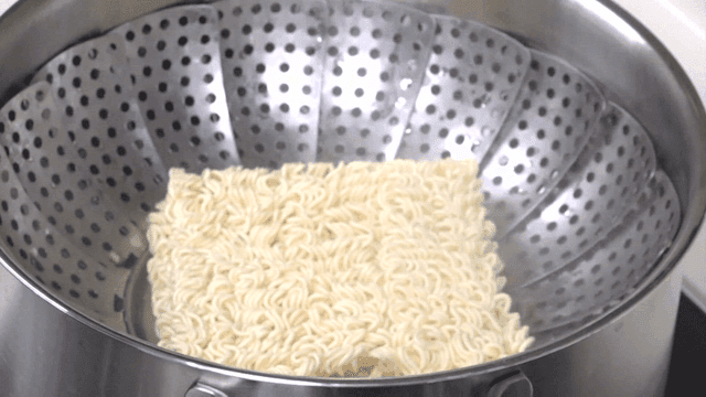 Ramen noodles placed in a stainless steamer
