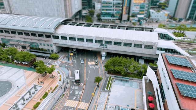 City train station with parking lot and road