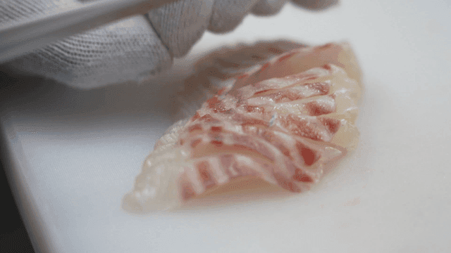 Fresh fish fillets are delicately sliced ​​into sashimi