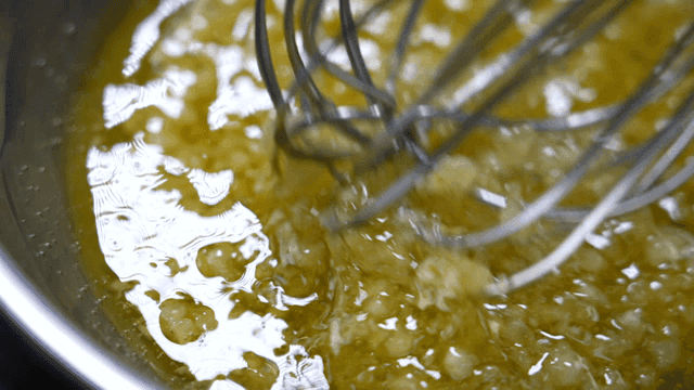 Mixing minced garlic in olive oil