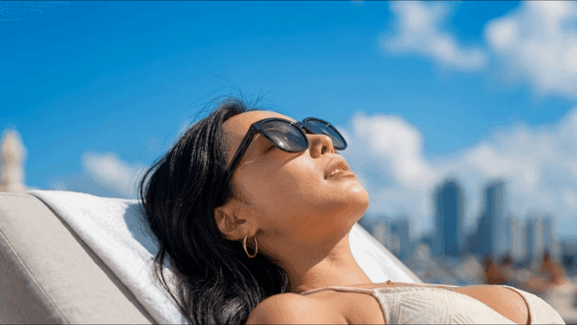 Woman relaxing under the sun with sunglasses