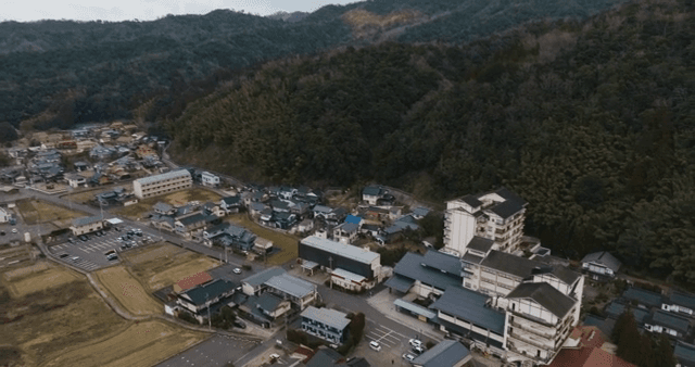 Small town surrounded by lush hills