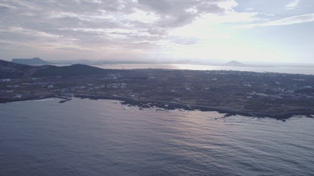 Coastal landscape with distant mountains