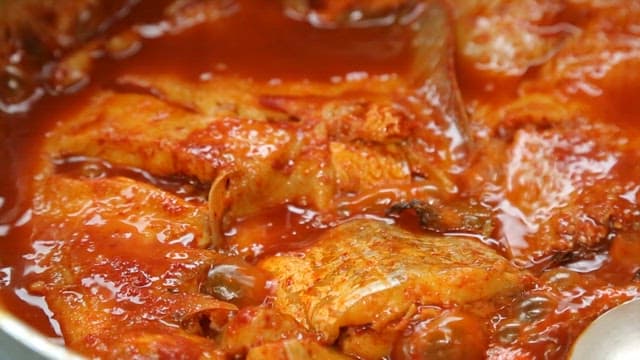 Steamed fish containing various fish simmering in a pot