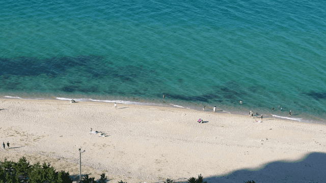 A sunny beach with people relaxing