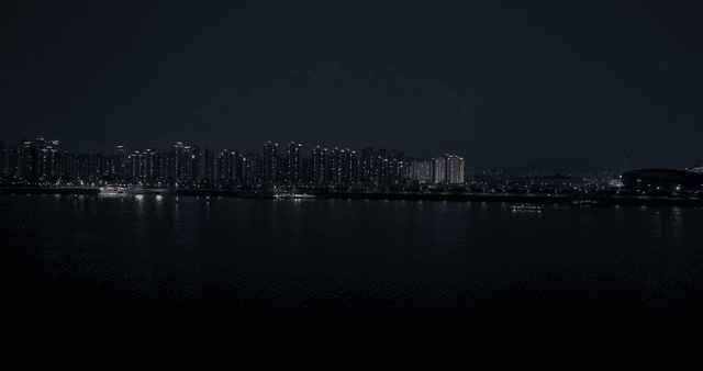 Night view of a city skyline by the river