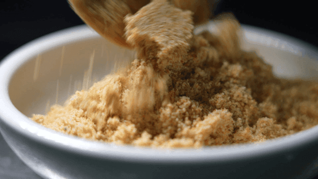 Brown salt poured into white bowl