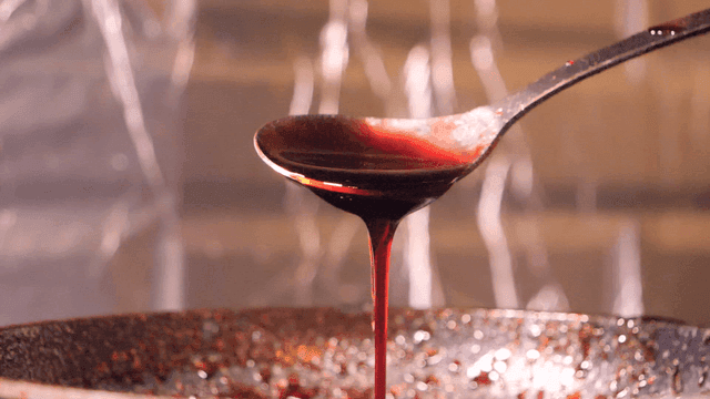 Spoon dripping thick wine sauce