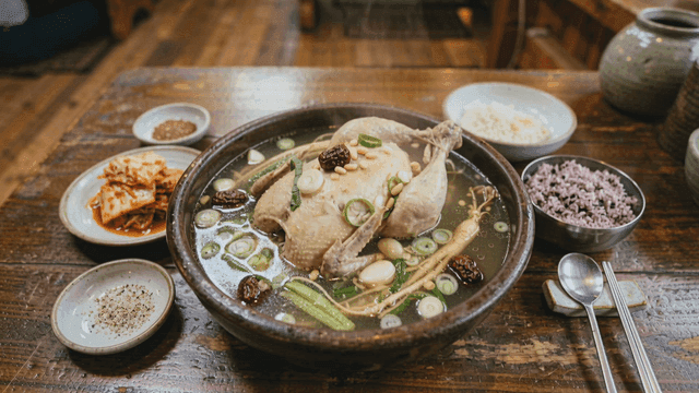 Samgyetang served with side dishes in a cozy restaurant