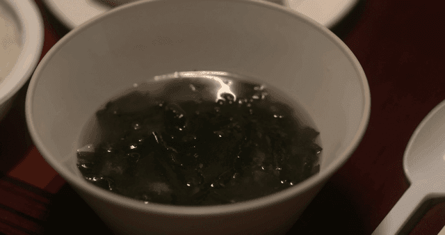 Bowl of seaweed soup on table