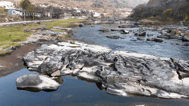 Quiet river flowing through village.