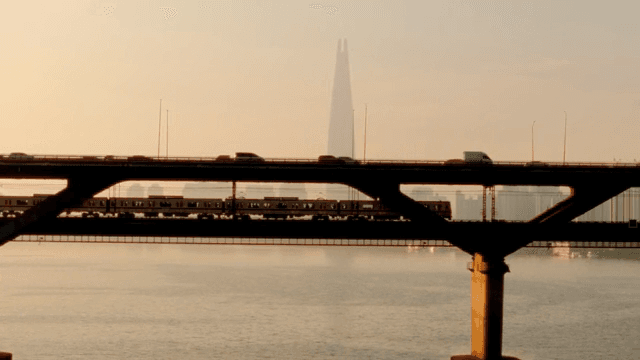 Bridge with a subway and cars at sunset