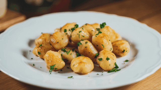 Golden brown gnocchi garnished with herbs