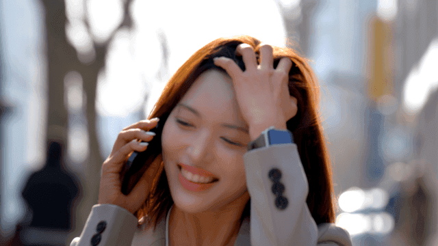 Female office worker talking on phone while walking