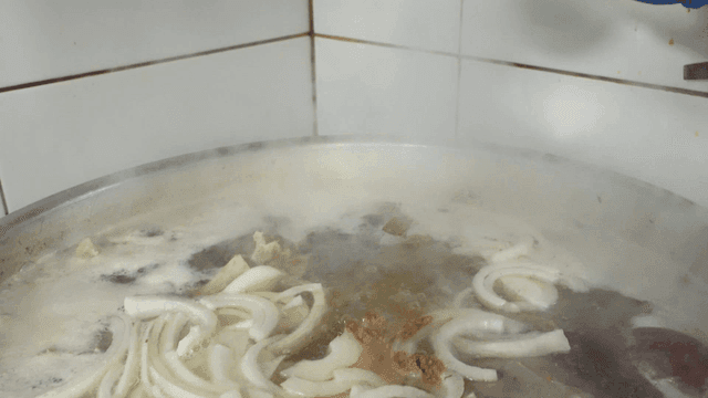 Spices sprinkled on boiling pot