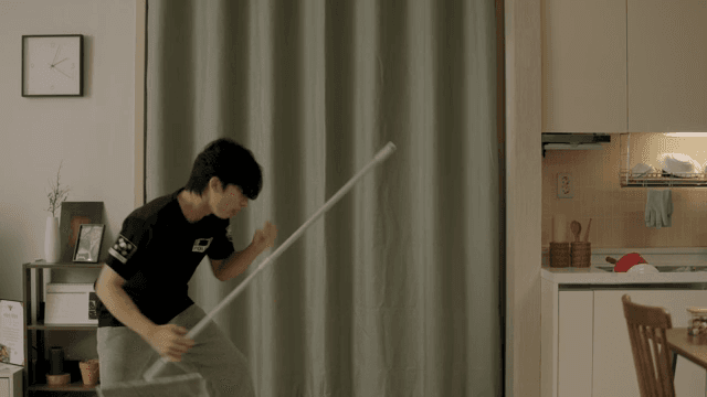 거실을 흥겹게 청소하는 남자