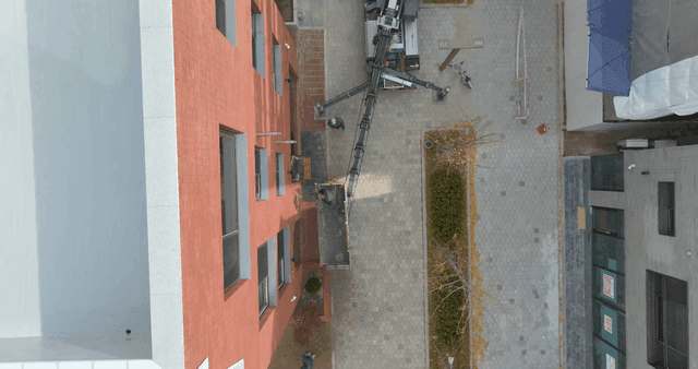 Building construction underway with lift