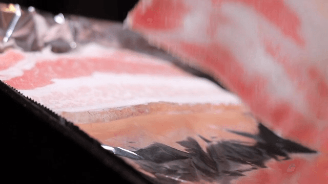Grilling frozen pork belly on a foil-lined pan
