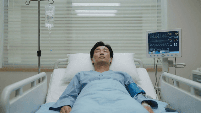 Male patient resting in hospital bed