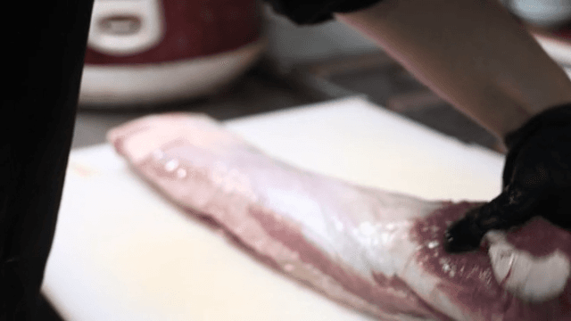 Chef preparing raw meat in kitchen