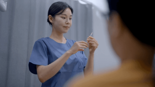 A nurse preparing a syringe in a clinic