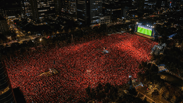 Large crowd watching a sports event at night