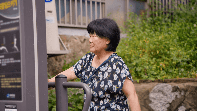 야외 운동 기구를 사용하는 노인 여성