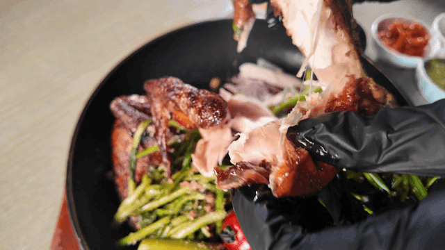 Fresh vegetables and grilled chicken tearing gloves