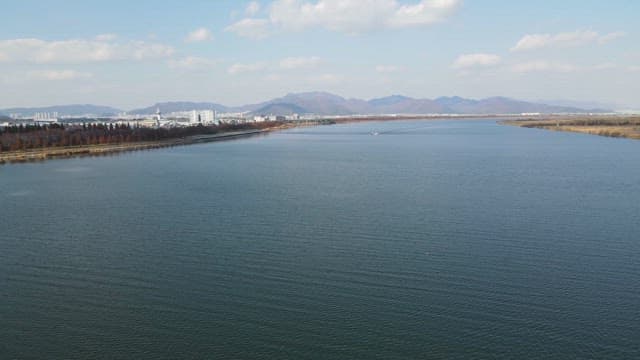 Wide river with distant cityscape