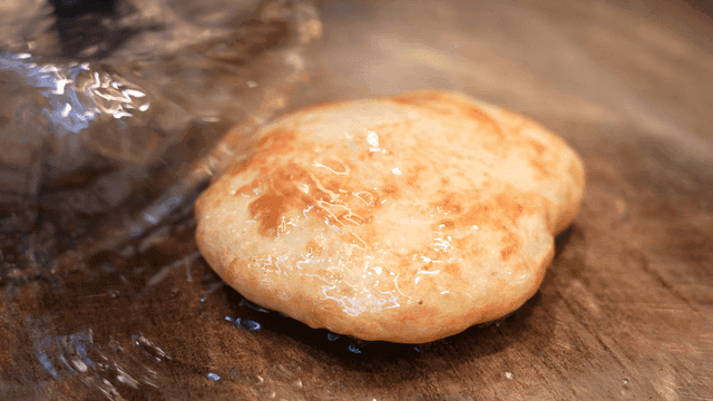 Korean pancake sizzling on a hot griddle
