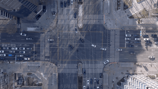 Busy city intersection with vehicles.